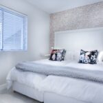 Home Elegant modern bedroom with stylish decor and plush bedding for a serene ambiance.