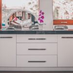 Home Contemporary kitchen island with an elegant orchid decoration and stylish furniture.