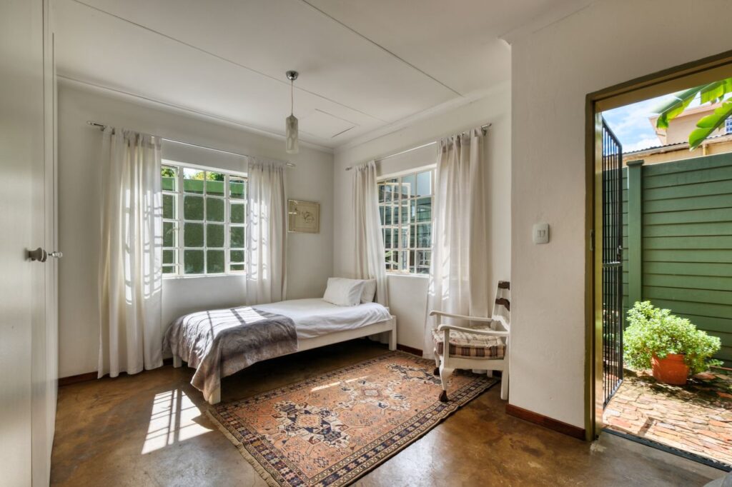 Inviting bedroom with rustic decor and outdoor access in Pretoria, South Africa.