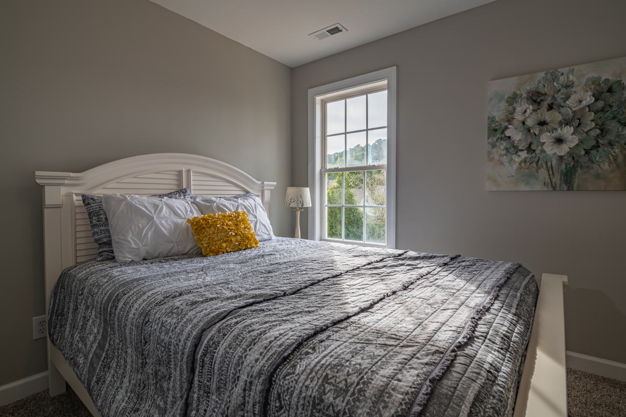 Bed A warm, inviting bedroom with a double bed and natural light streaming in.