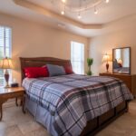 Home Inviting modern bedroom with plaid bedding and elegant furniture, perfect for relaxation.