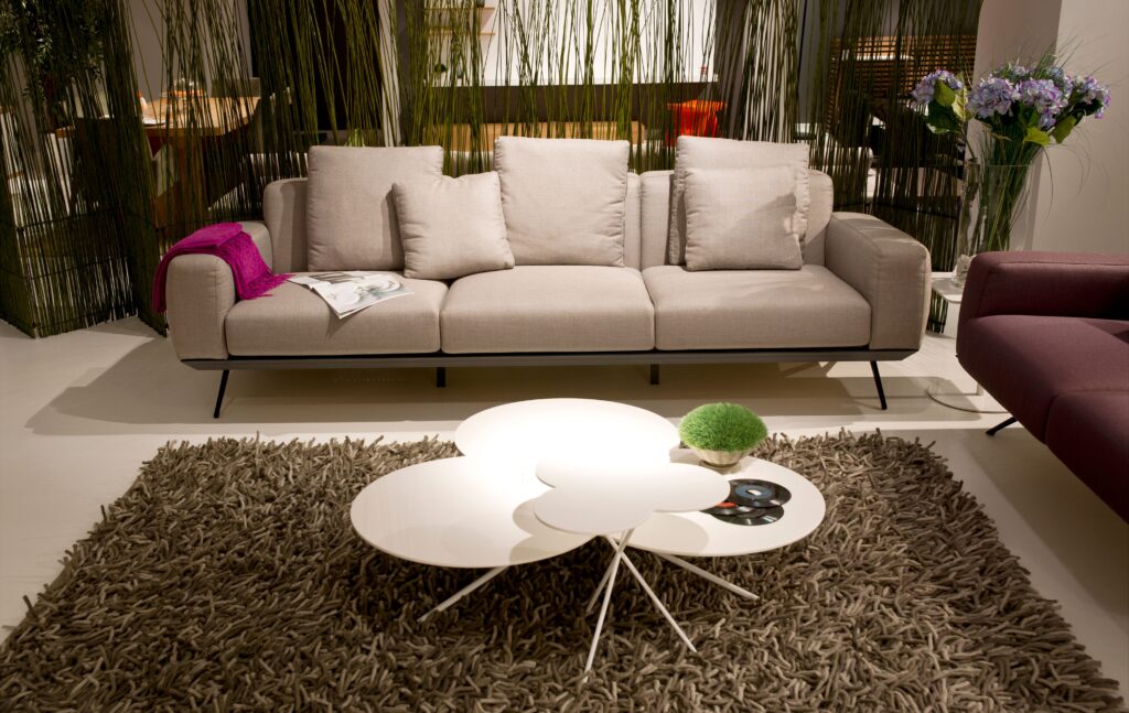 Elegant modern living room with a beige sofa, shaggy rug, and contemporary decor.