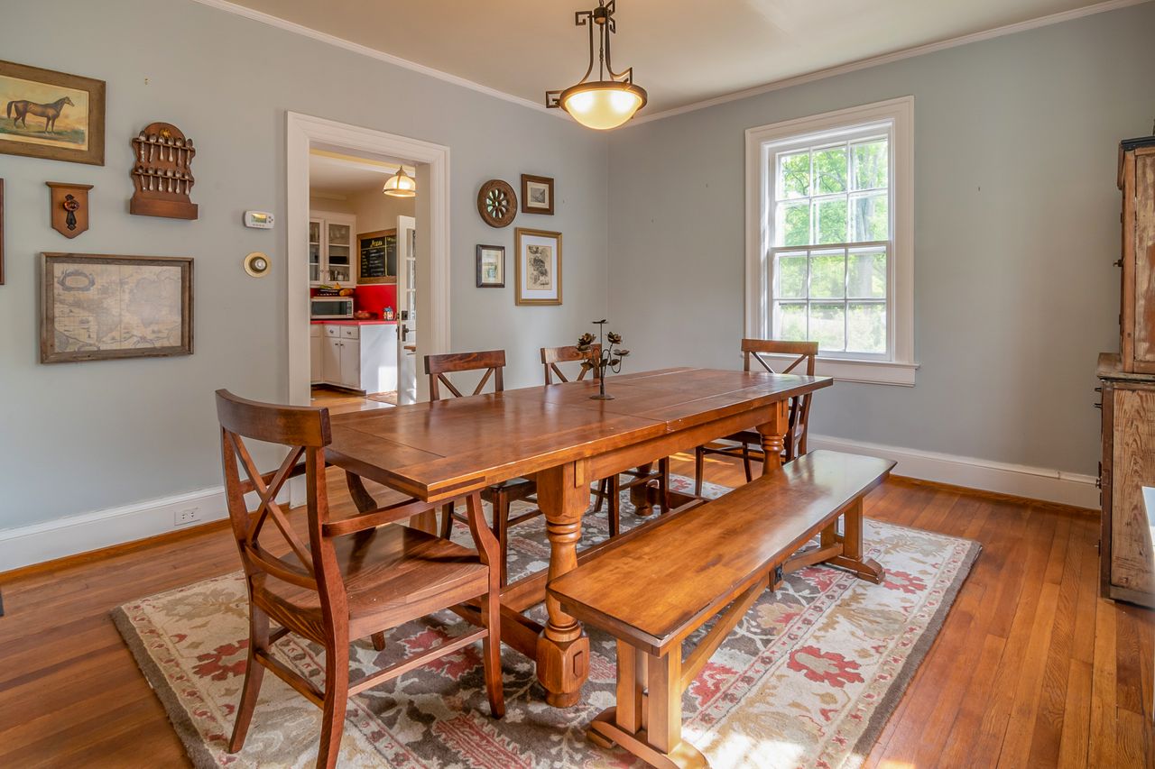 Inviting dining room featuring wooden furniture and rustic wall decor, perfect for family gatherings.