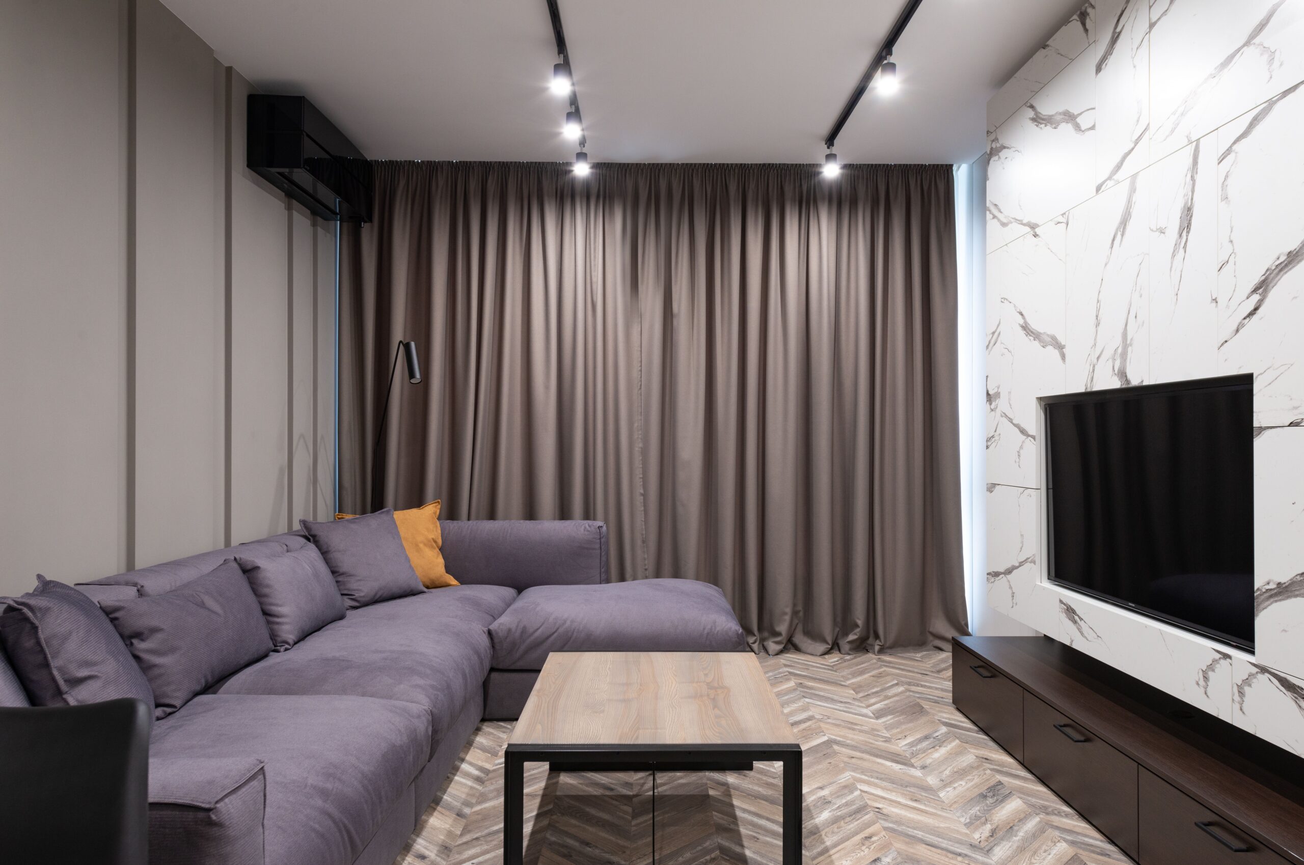 Home Elegant modern living room with corner sofa and minimalist decor showcasing simplicity.
