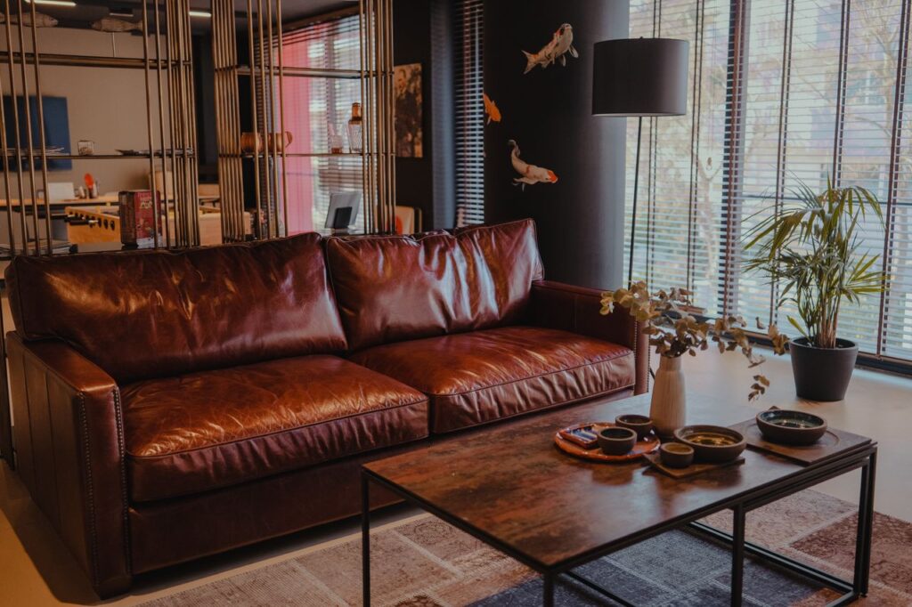 Cozy living room with a brown leather sofa and stylish decor elements.