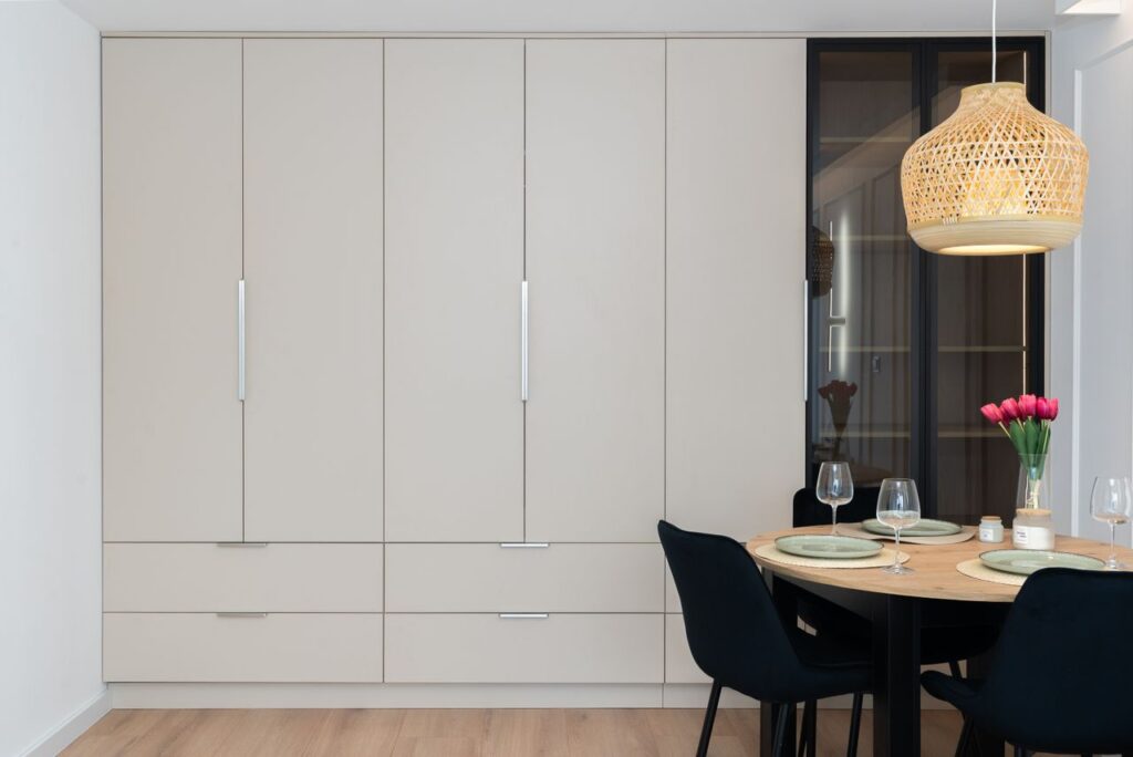 Minimalist dining space with a stylish light fixture and elegant table setting.