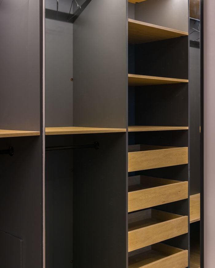 Minimalist modern wardrobe with empty shelves and hangers, perfect for organization.